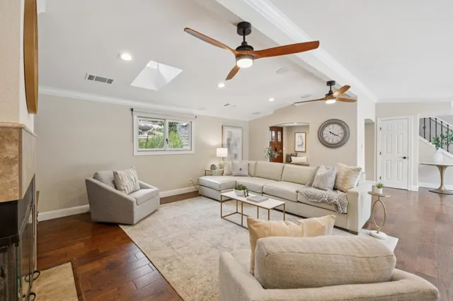 a living room with furniture a flat screen tv and a fireplace