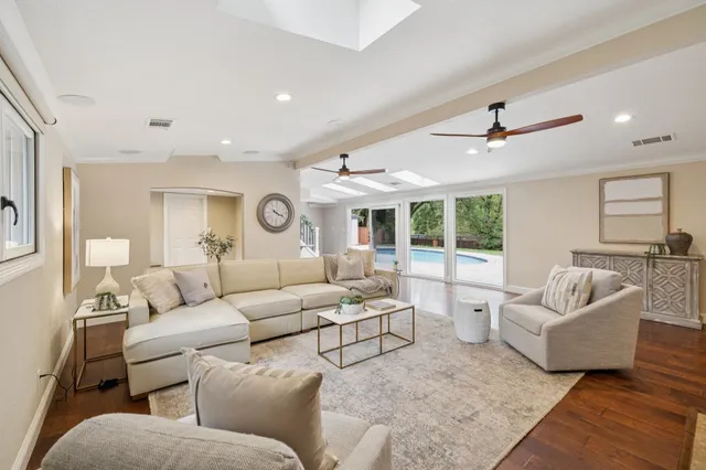 a living room with furniture a fireplace and a flat screen tv