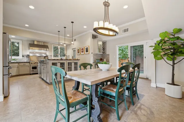 a kitchen with kitchen island granite countertop a stove a sink a center island and cabinets