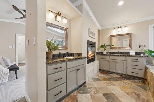 a bathroom with a granite countertop sink vanity mirror next to a cabinet
