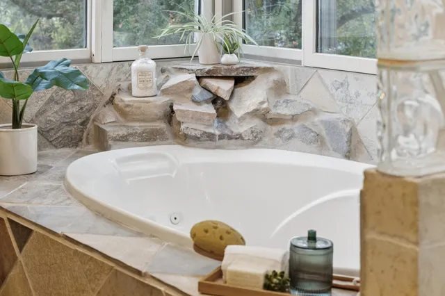 a spacious bedroom with a bed and a painting on the wall