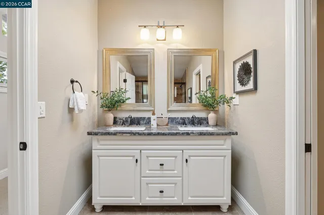 a utility room with wooden floor washer and dryer