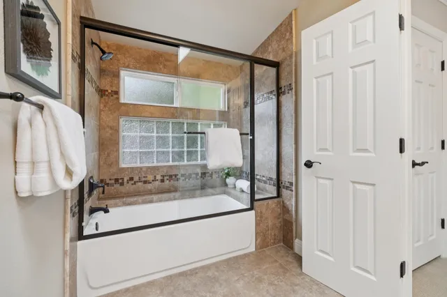 a living room with furniture flat screen tv and a large window