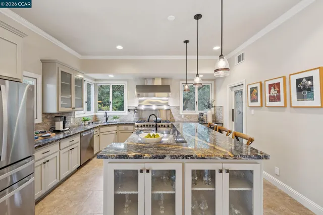 a kitchen with a stove a sink a refrigerator and window