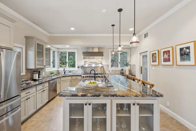 a kitchen with furniture a sink a stove and window