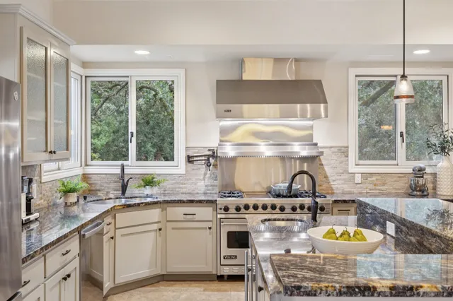 a dining room with furniture a chandelier and wooden floor