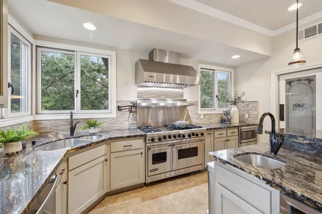 a kitchen with a sink stove and cabinets
