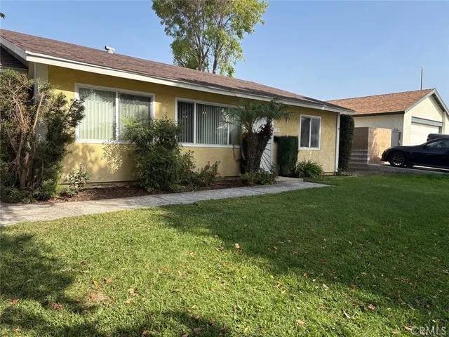 a front view of a house with a yard and porch