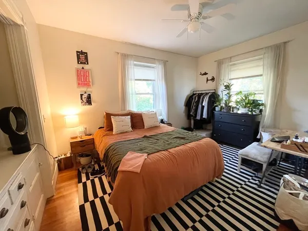 a bedroom with double bed and a chandelier