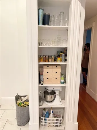 a kitchen with stainless steel appliances kitchen island granite countertop a table and a microwave