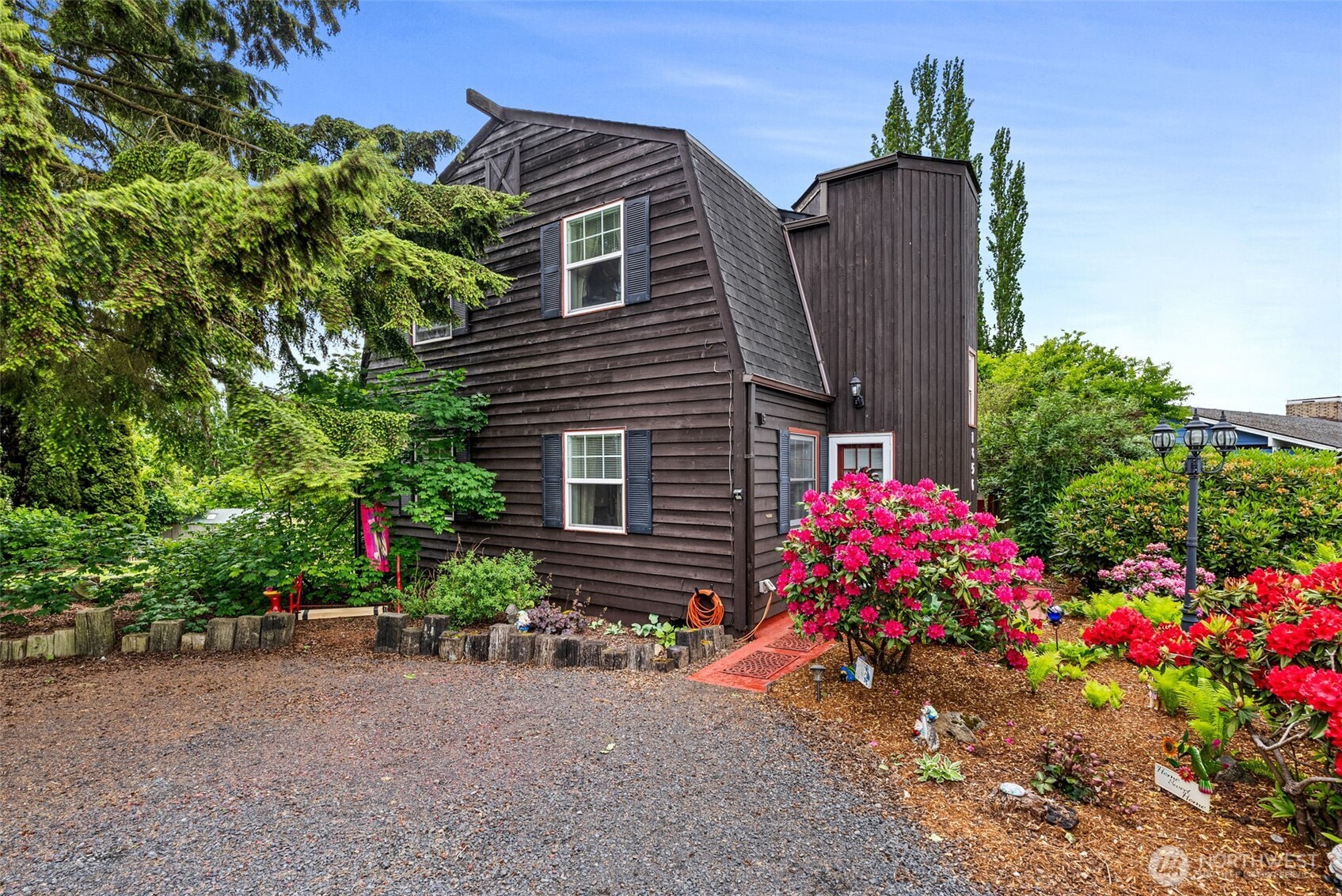 a view of a house with a backyard and garden