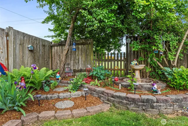 a garden with flowers and trees