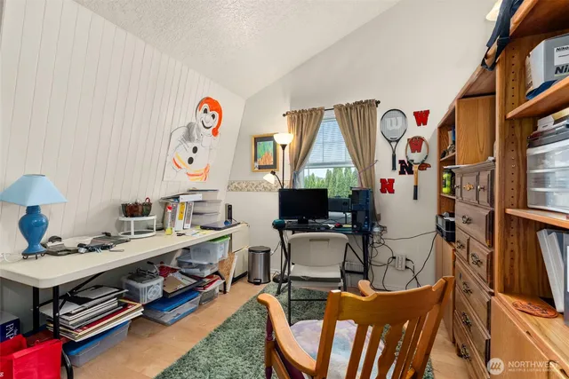 a room with furniture a rug and a fan