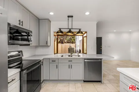 a kitchen with a sink stove and microwave