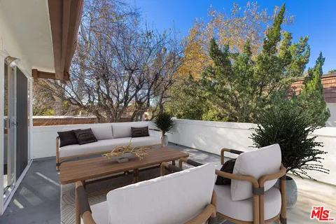 a view of an outdoor sitting area with furniture and wooden floor