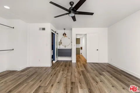 a view of empty room with wooden floor