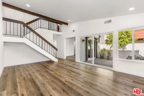a view of an entryway with wooden floor