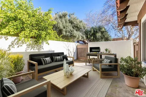a outdoor living space with furniture and a potted plant