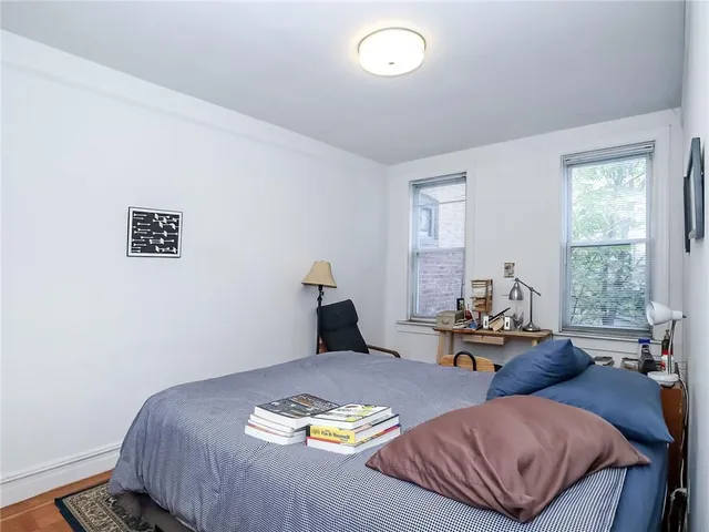 a bedroom with a bed and a potted plant