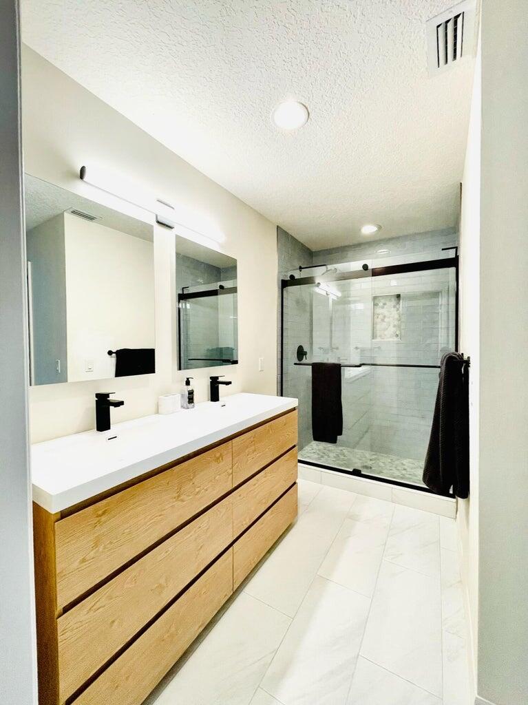 1420 Ocean Way, Unit 32C Jupiter, FL 33477 - Photo 12 of 22 a bathroom with a sink and a mirror