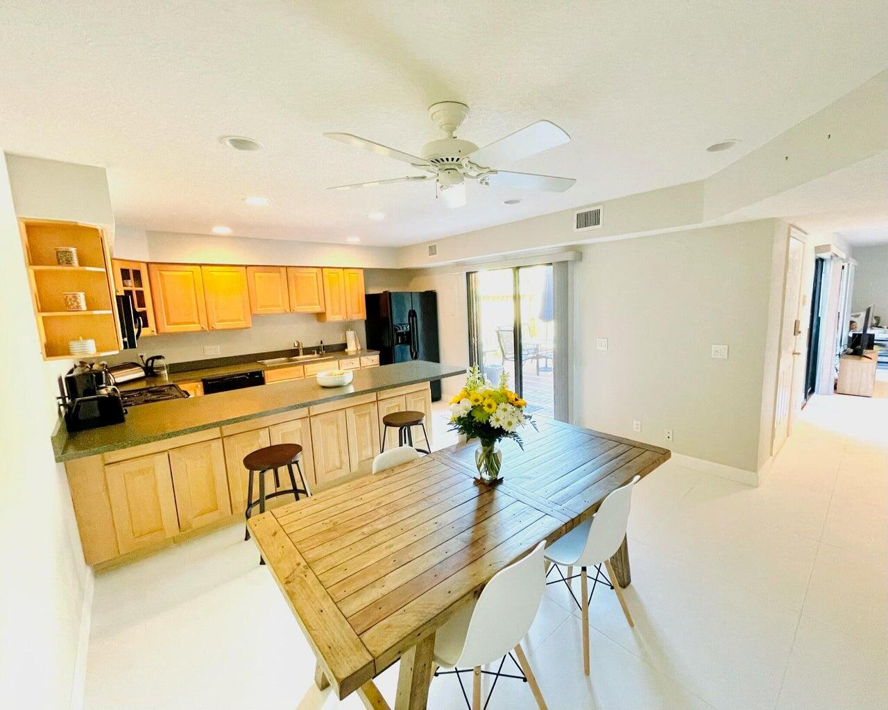 1420 Ocean Way, Unit 32C Jupiter, FL 33477 - Photo 4 of 22 a room with furniture and flat screen tv