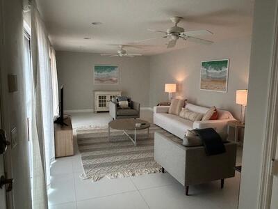 1420 Ocean Way, Unit 32C Jupiter, FL 33477 - Photo 6 of 22 a living room with furniture and a chandelier