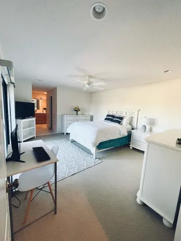a bedroom with furniture and a flat screen tv