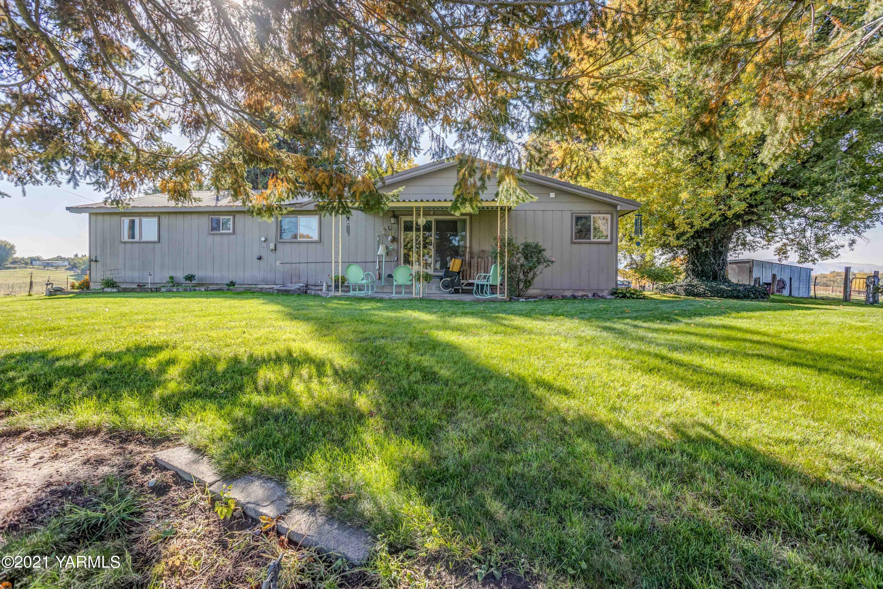 800 Blaine Road Granger, WA 98932 - Photo 19 of 43 a view of a house with a big yard and large trees
