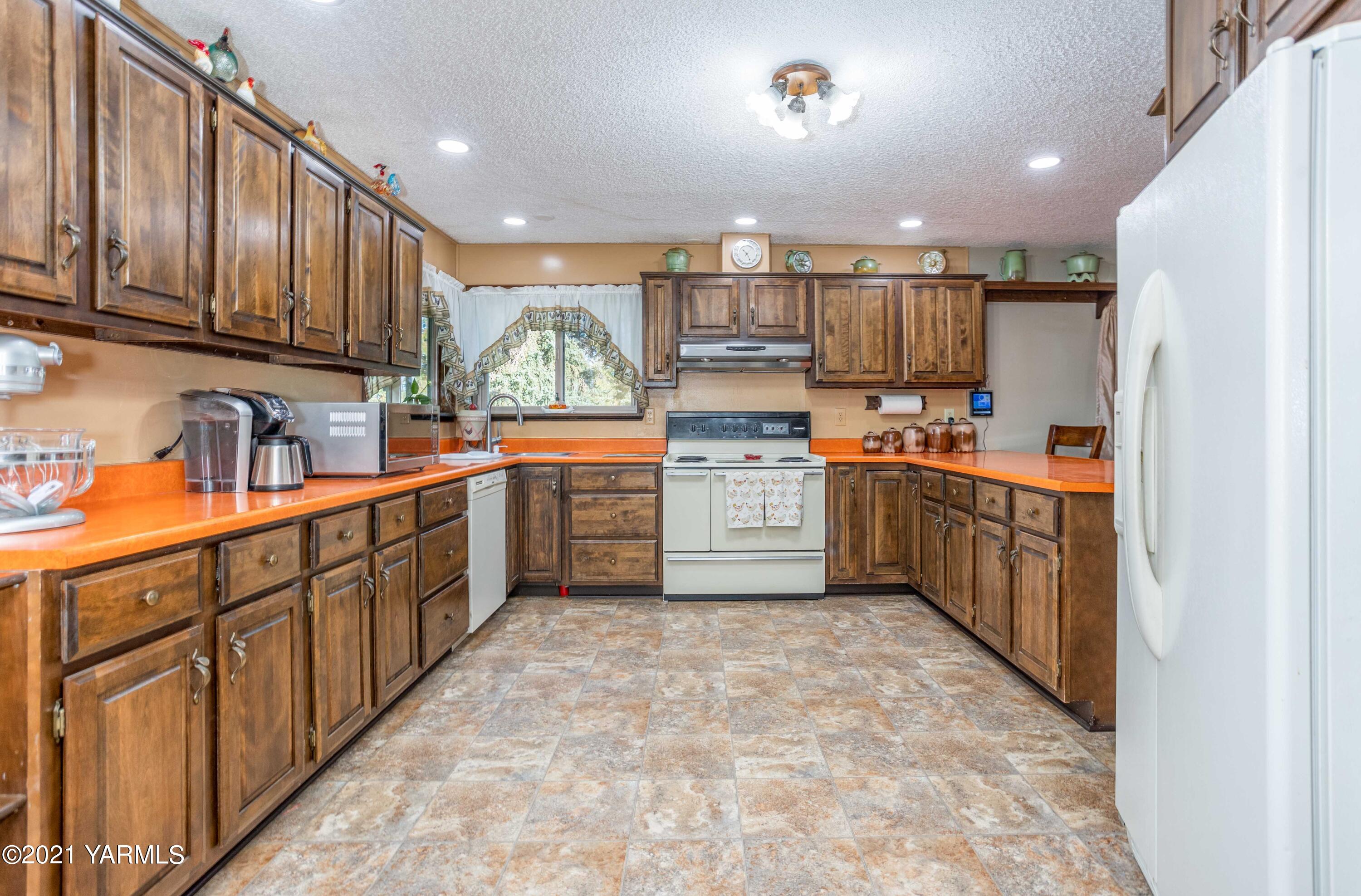 800 Blaine Road Granger, WA 98932 - Photo 8 of 43 a kitchen with stainless steel appliances granite countertop a sink counter space cabinets and a large window