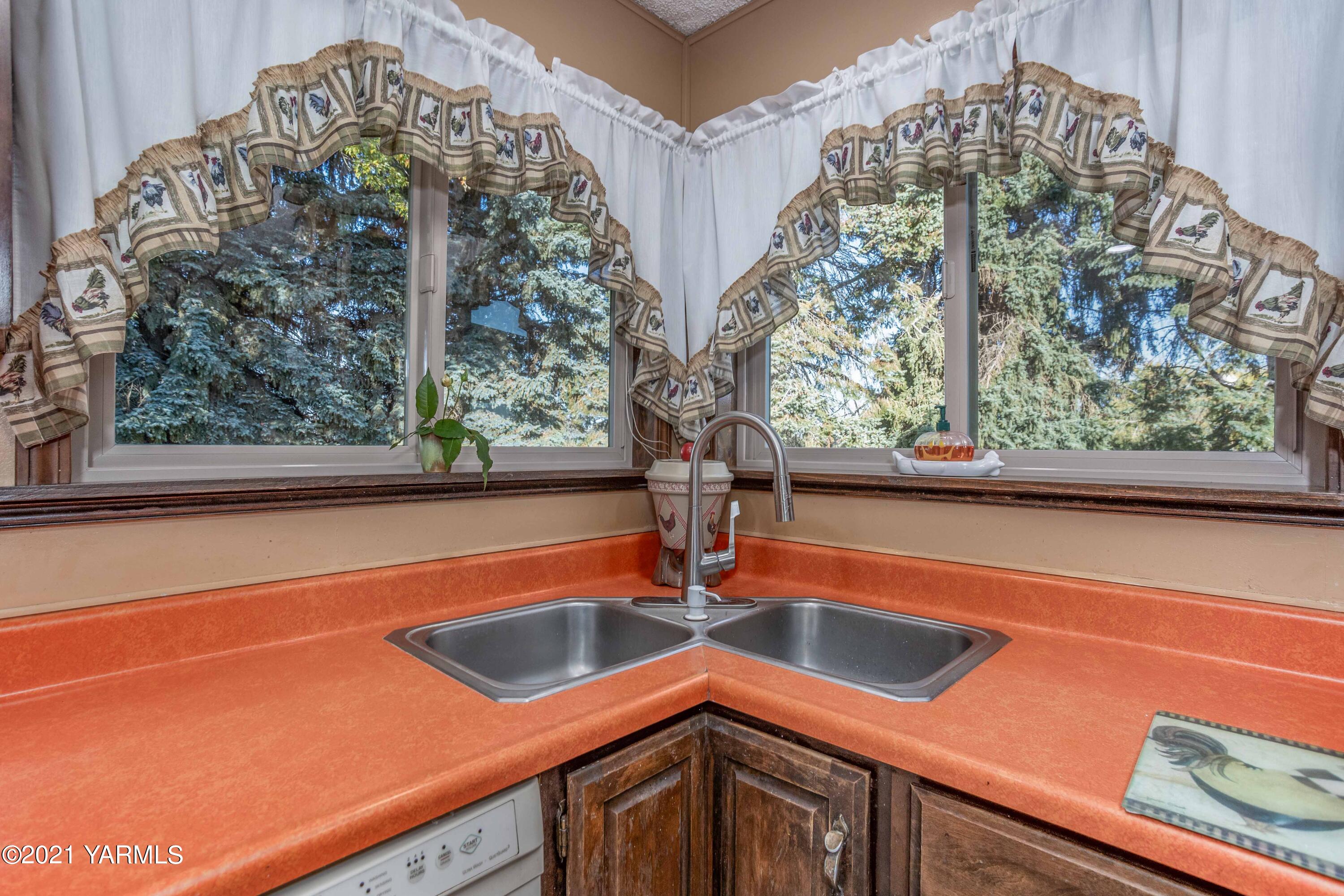 800 Blaine Road Granger, WA 98932 - Photo 9 of 43 a view of a sink and table with chairs