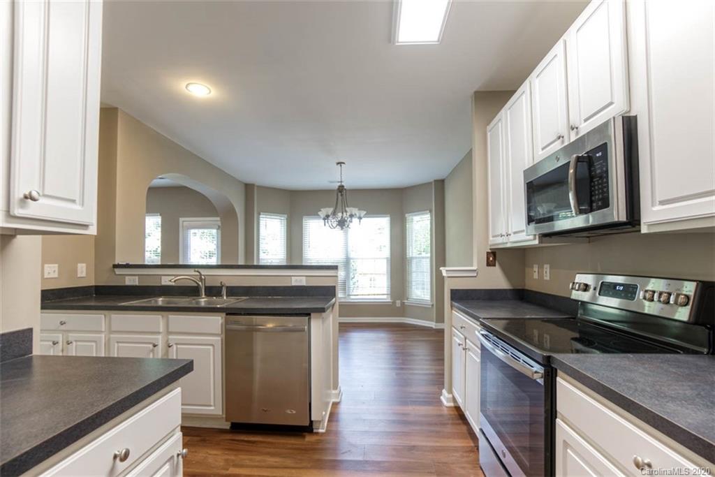 2515 Fossil Stone Lane Fort Mill, SC 29708 - Photo 11 of 37 a kitchen with stainless steel appliances granite countertop a stove a sink and a microwave