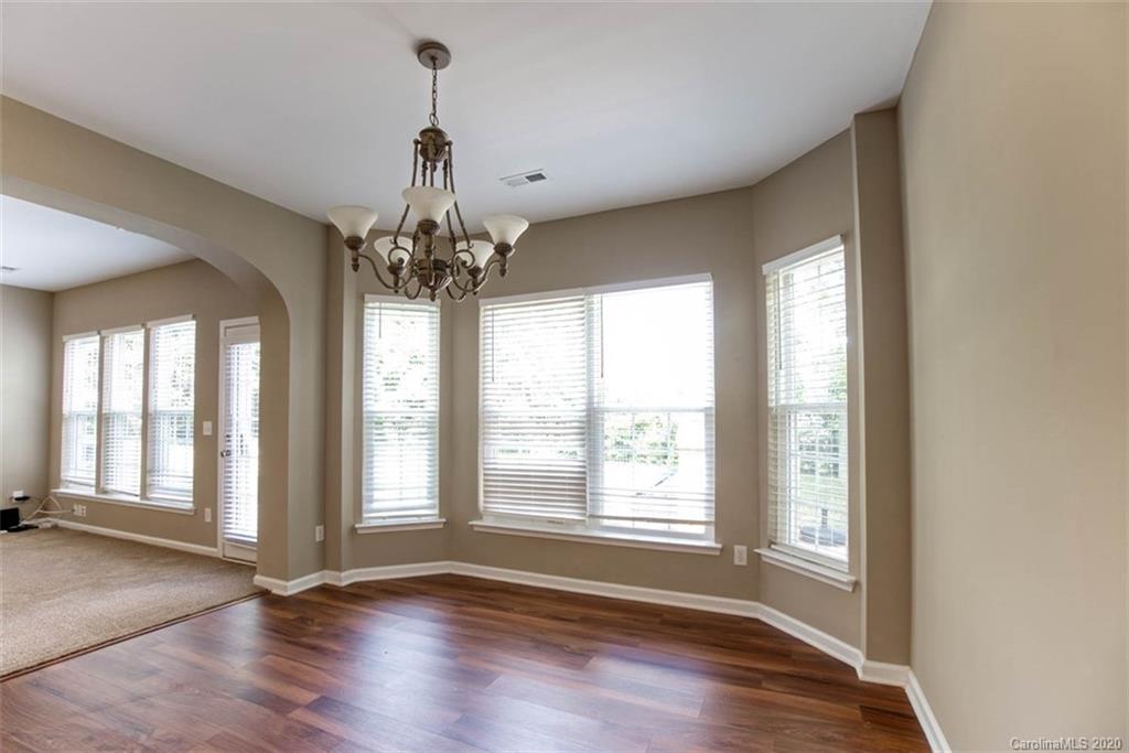 2515 Fossil Stone Lane Fort Mill, SC 29708 - Photo 12 of 37 a view of an empty room with wooden floor and a window