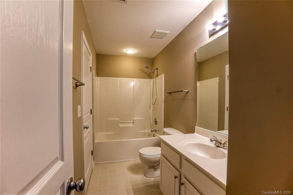 2515 Fossil Stone Lane Fort Mill, SC 29708 - Photo 20 of 37 a bathroom with a granite countertop toilet a sink and a mirror