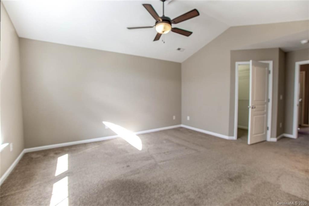2515 Fossil Stone Lane Fort Mill, SC 29708 - Photo 29 of 37 an empty room with closet and a ceiling fan