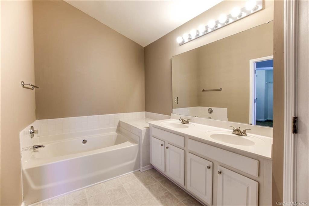 2515 Fossil Stone Lane Fort Mill, SC 29708 - Photo 33 of 37 a bathroom with a tub sink and mirror