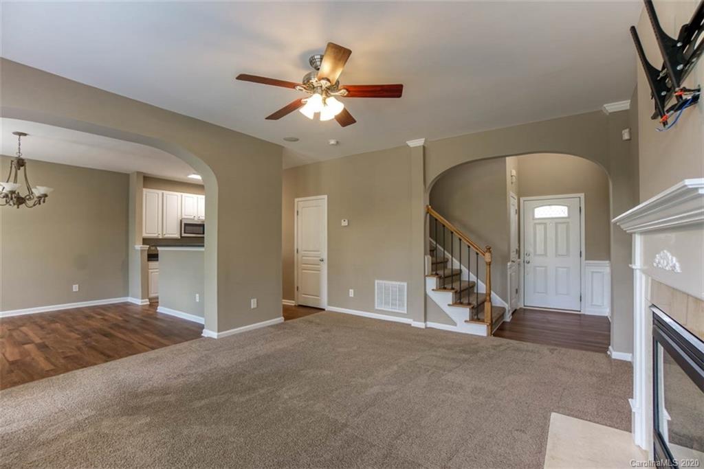 2515 Fossil Stone Lane Fort Mill, SC 29708 - Photo 5 of 37 a view of a livingroom with a ceiling fan and window