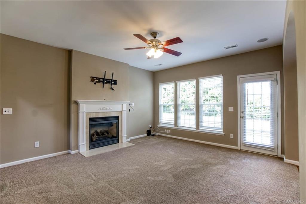 2515 Fossil Stone Lane Fort Mill, SC 29708 - Photo 6 of 37 a view of livingroom with fireplace fan and a window