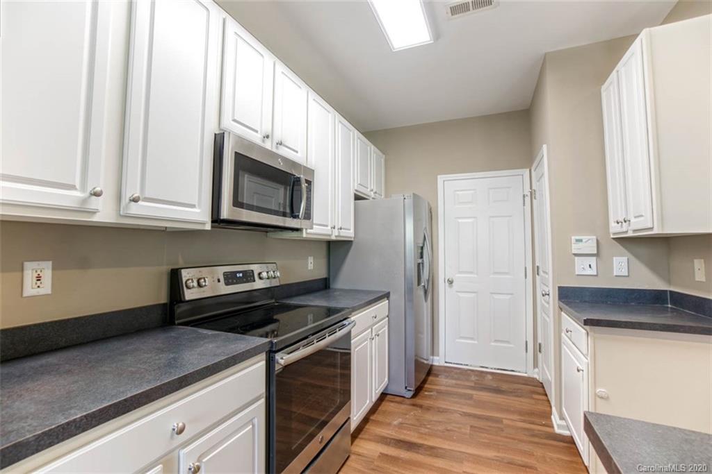 2515 Fossil Stone Lane Fort Mill, SC 29708 - Photo 10 of 37 a kitchen with stainless steel appliances granite countertop a stove a microwave and a refrigerator