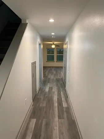 a view of hallway with wooden floor