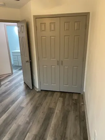 a view of a hallway with wooden floor