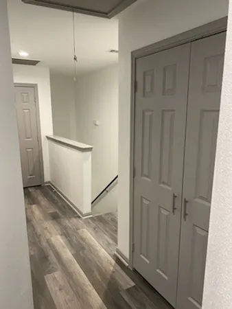 a view of a hallway to rooms