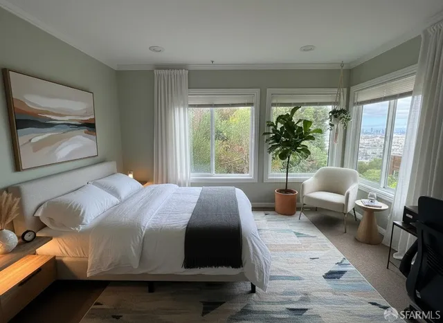 a bedroom with a large bed and a large window