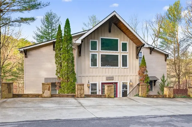 a kitchen with stainless steel appliances granite countertop a stove top oven a refrigerator a dining table and chairs with wooden floor