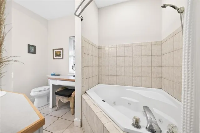 a bedroom with a large bed and a tv