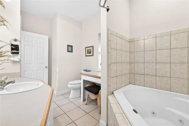 a bedroom with a large bed and a flat screen tv