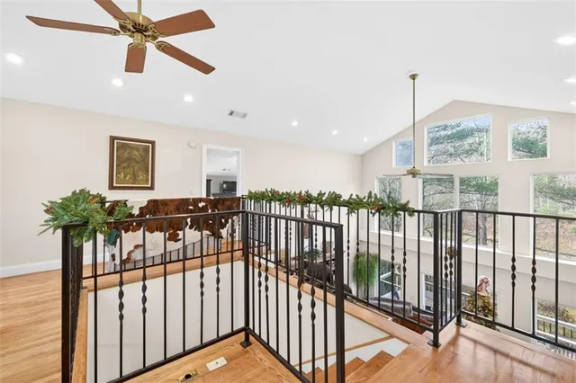 a living room with furniture a flat screen tv and a large window
