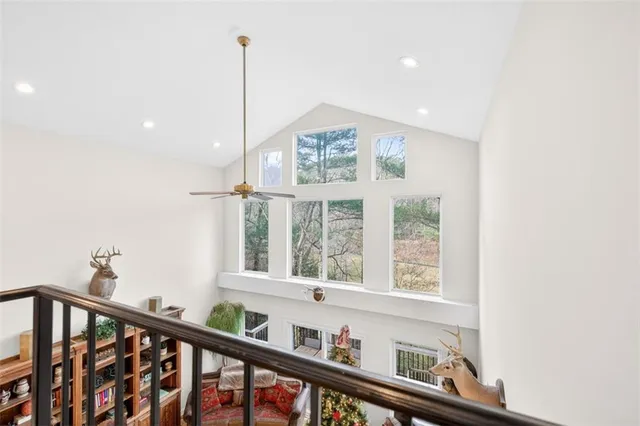 a kitchen with stainless steel appliances granite countertop a refrigerator a sink dishwasher and white cabinets with wooden floor