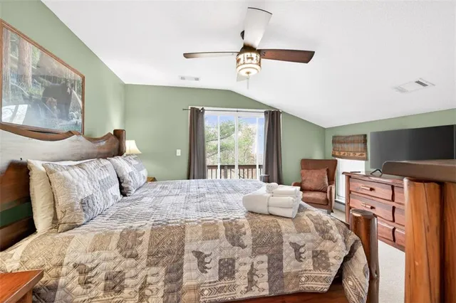 a bedroom with a large bed and a large window