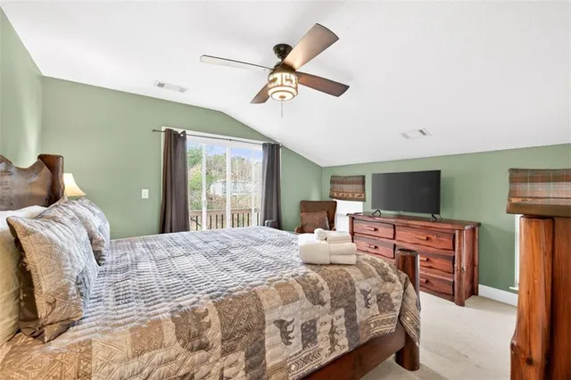 a view of balcony with floor to ceiling windows and wooden fence