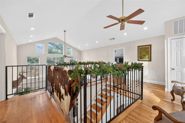 a living room with furniture and a dining table next to a large window